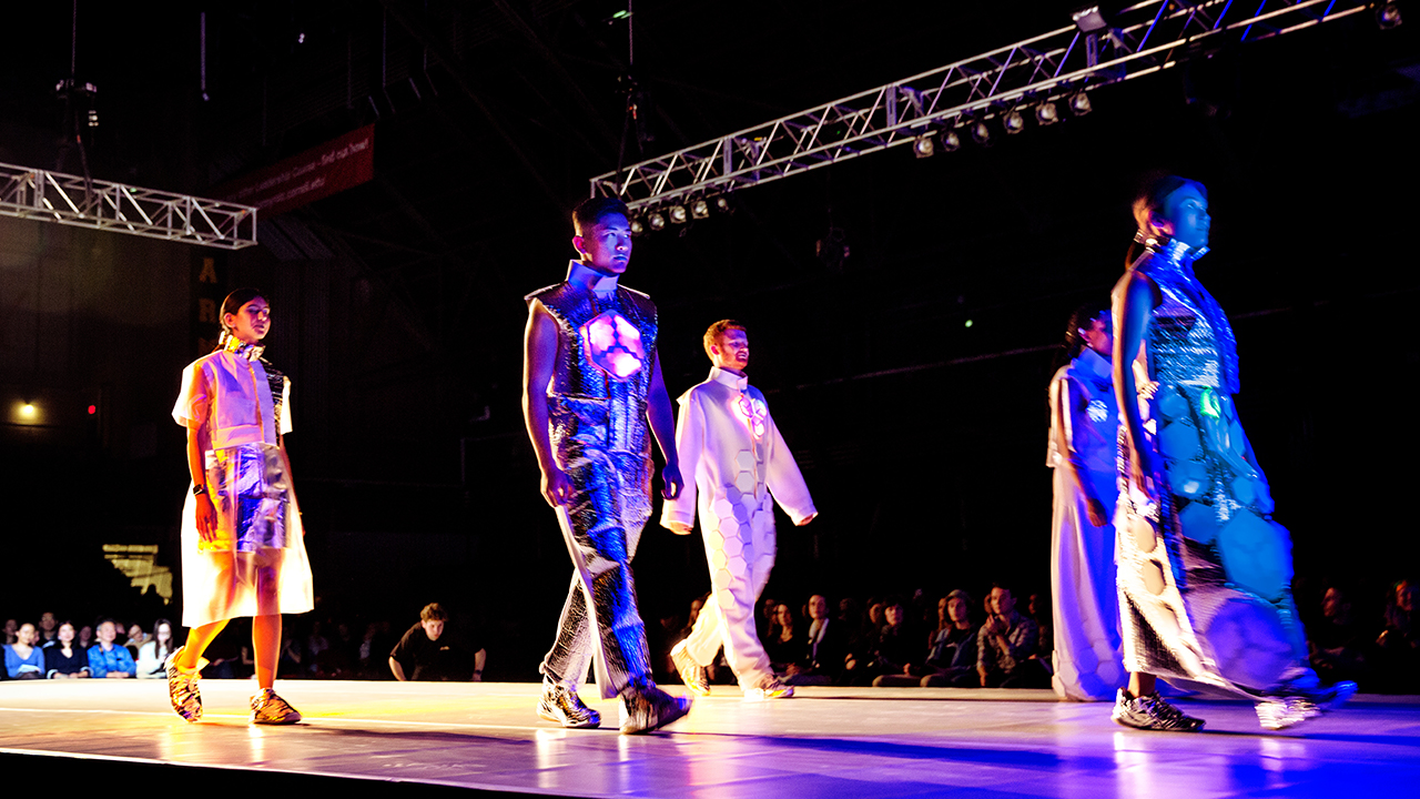 People walk the runway at the fashion show.