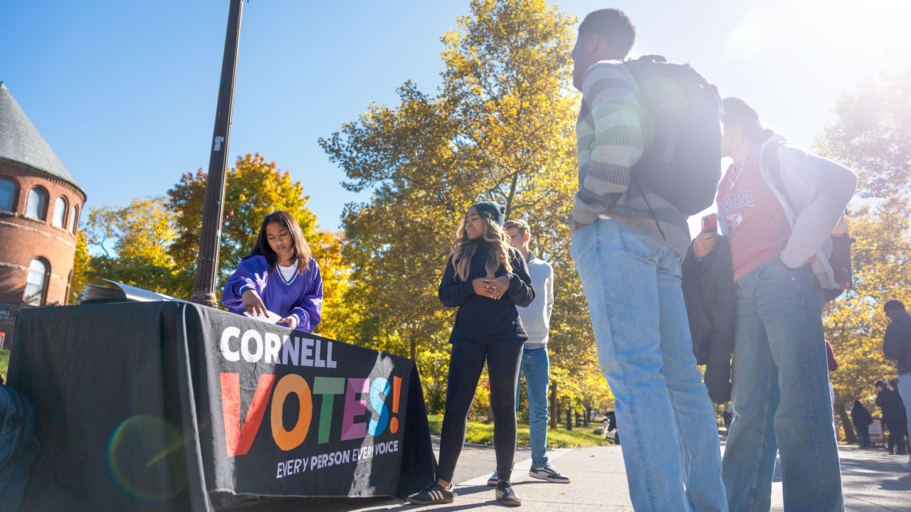 Students from the Cornell Policy Group, a nonpartisan student organization, help others register to vote on Ho Plaza.