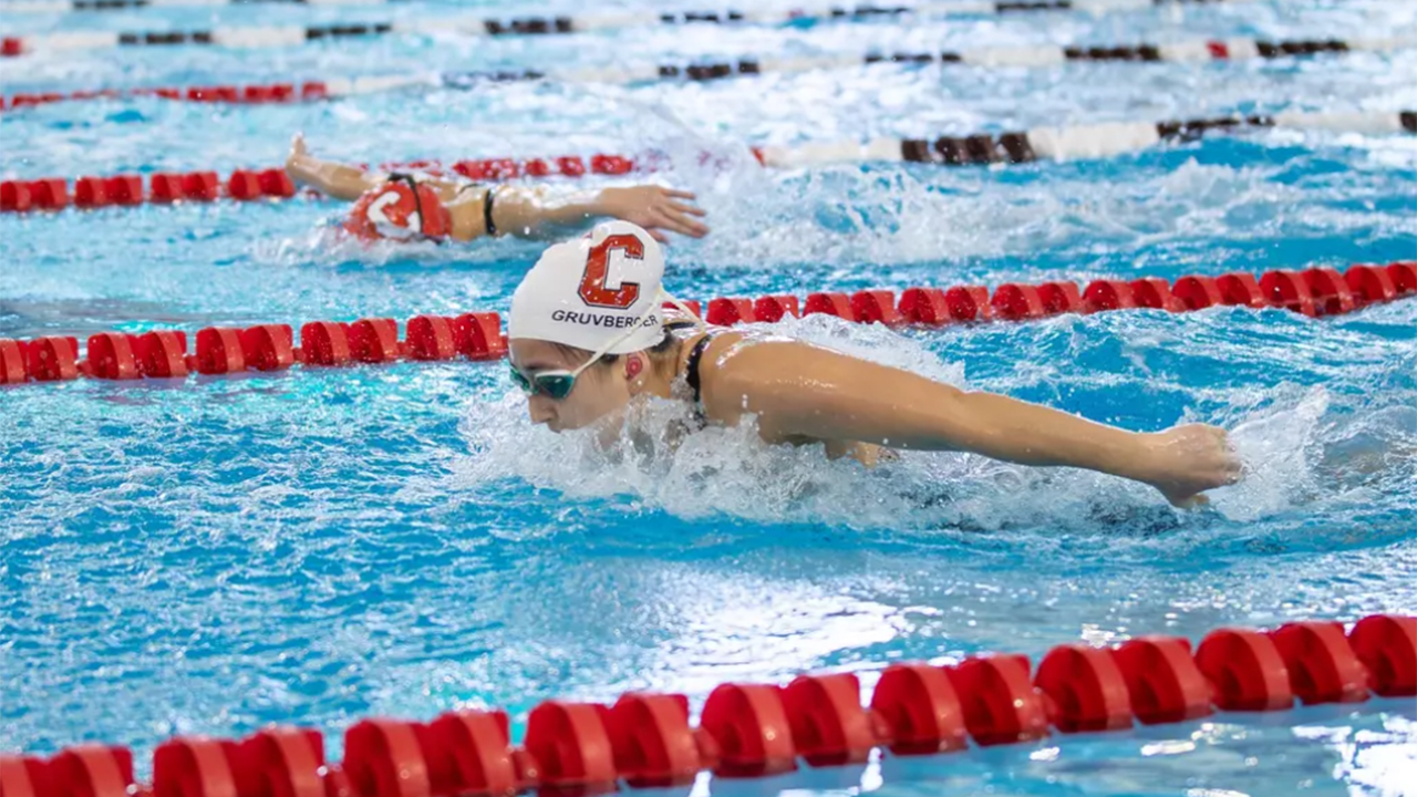 A team member of the Women's Swimming Team racing.